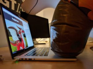 Inflatable standing fox typing on laptop
